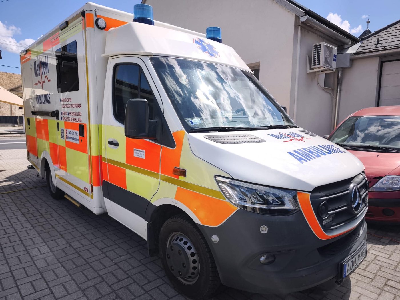 MediBeM ambulance from the side, with the list of services on the body